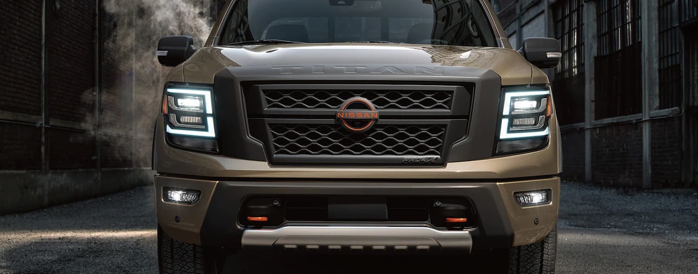 A front view of a brown 2023 Nissan Titan is parked in an alley after checking out a used car dealership near Newark.
