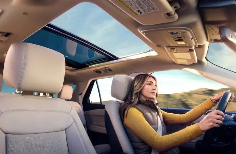 Woman driving 2020 Ford Explorer ST with Panoramic Sunroof in frame
