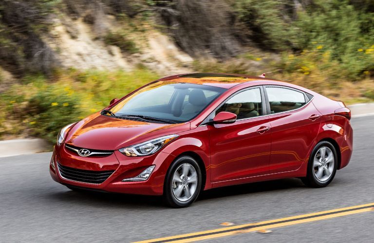 A 2016 Hyundai Elantra on a smooth road backdropped by rugged terrains