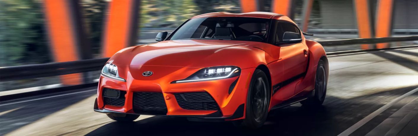 A 2024 Toyota GR Supra 45th Anniversary Edition speeding on  a road