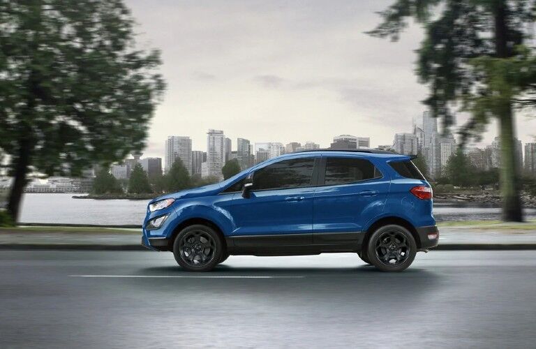blue 2021 Ford EcoSport side view by a city