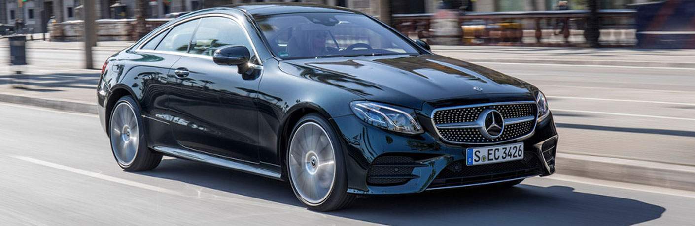 black Mercedes-Benz E-Class cruising the city