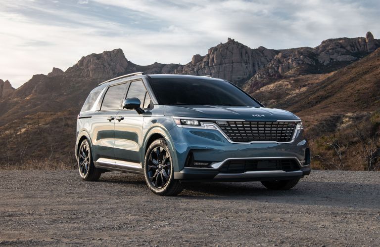 A 2024 Kia Carnival on a gritty terrain