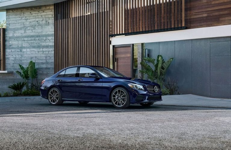 Mercedes-Benz C-Class Brilliant Blue Metallic parked outside a house