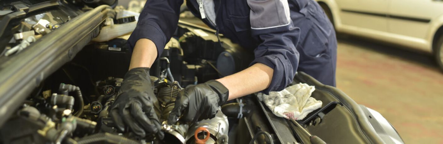 Technician checking the engine as part of the multi-point inspection service