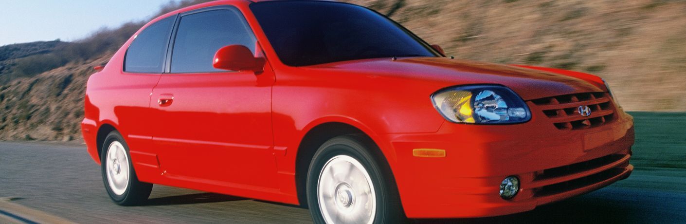 Side view of the 2003 Hyundai Accent on the road