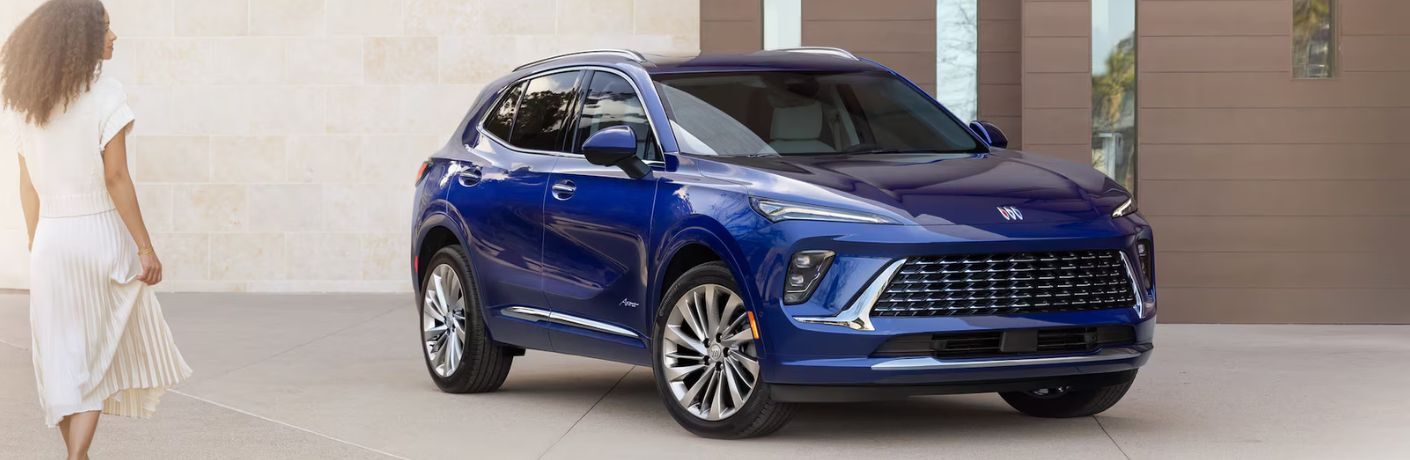 front quarter view of the 2025 Buick Envision with a woman in the foreground