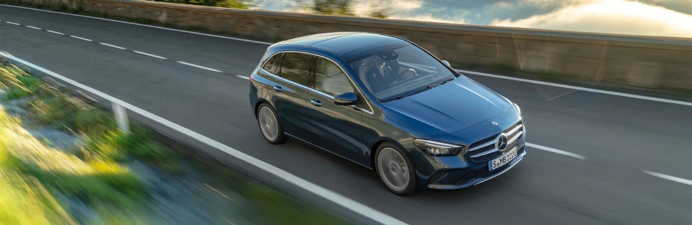 One blue color Mercedes-Benz B-Class is running on the road.