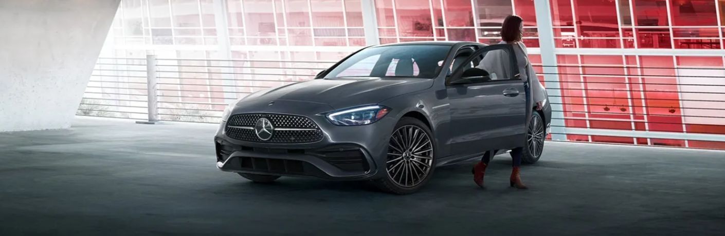 a woman getting out of a 2025 Mercedes-Benz C 300 Sedan