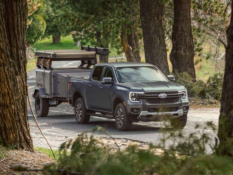 A front quarter view of the 2025 Ford Ranger XL towing a trailer.