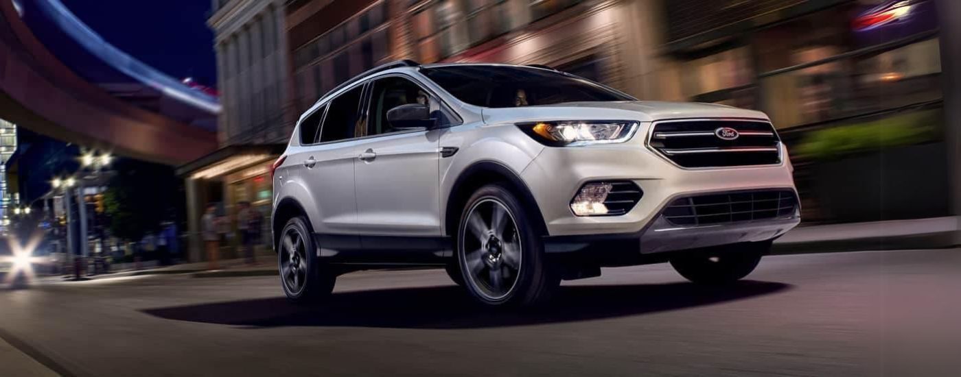 White 2019 Ford Escape driving down a city street.