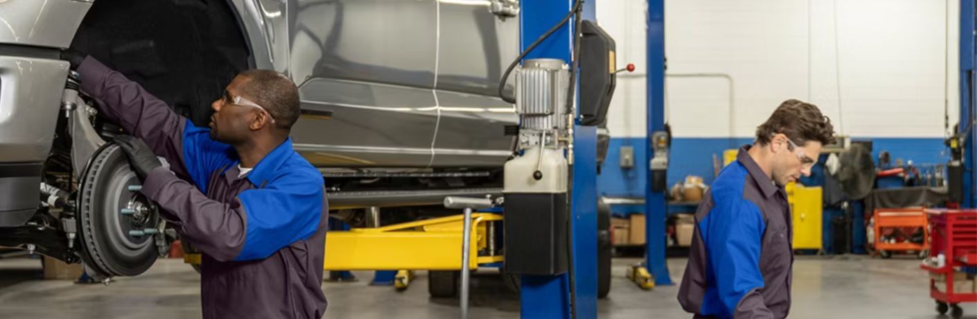 Ford technicians working on a car