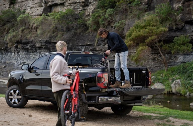 2025 Ford Ranger with two people loading the bed