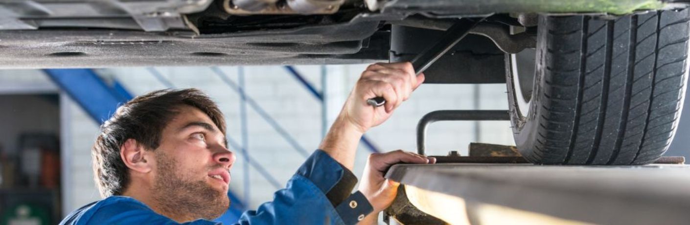 Car Mechanic checking the suspension system