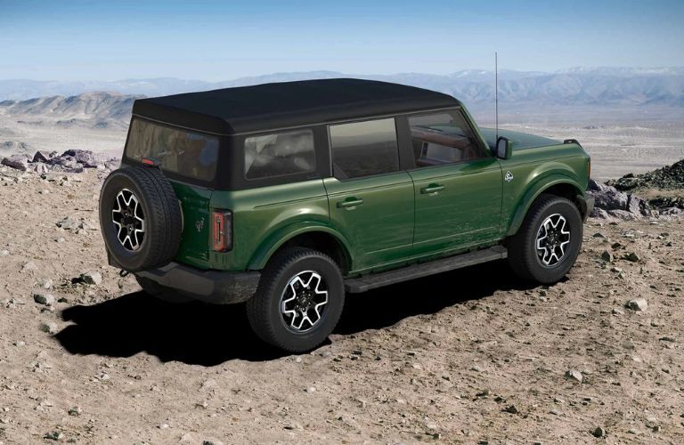 2025 Ford Bronco Outer Banks side and rear view on a rocky mountain