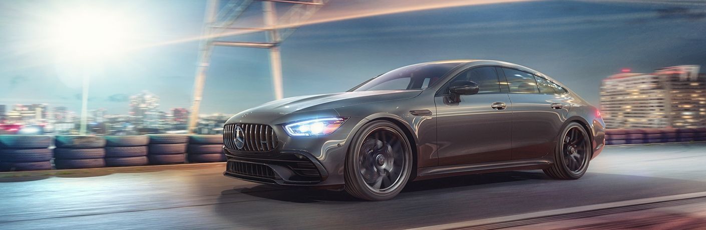 Front three-quarter view of the 2023 Mercedes-AMG GT 53 Coupe driving on a racetrack