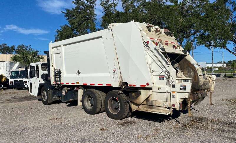 A used rear loading garbage truck from Dirt Cheap Truck Sales in Tampa, FL.