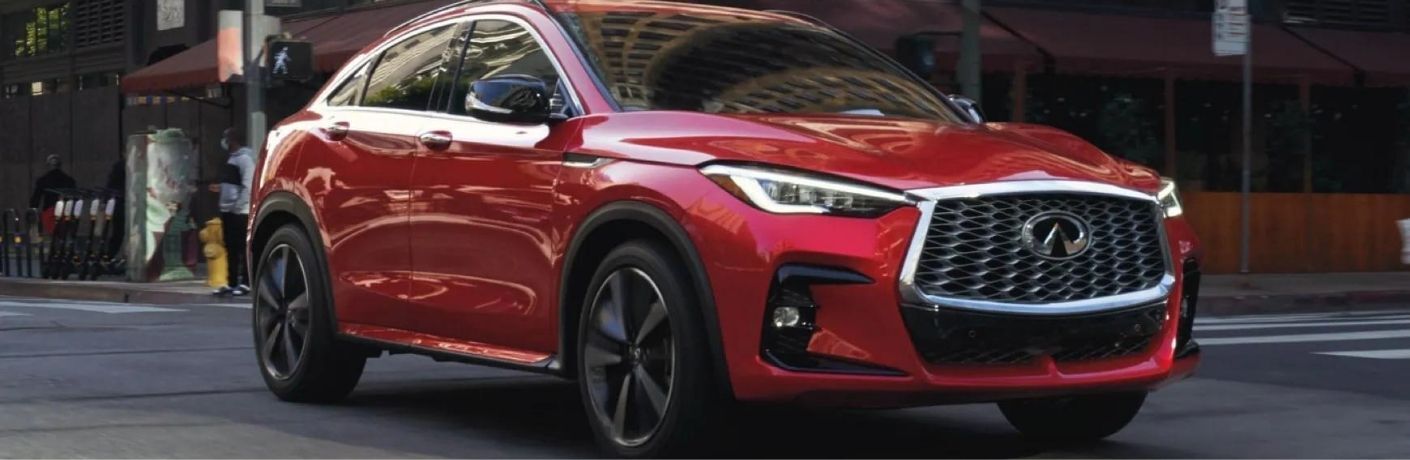 Used INFINITI vehicle driving on the road