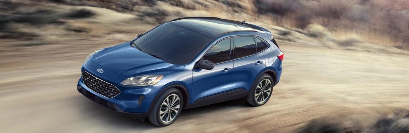 A blue 2022 Ford Escape zipping across a gritty terrain
