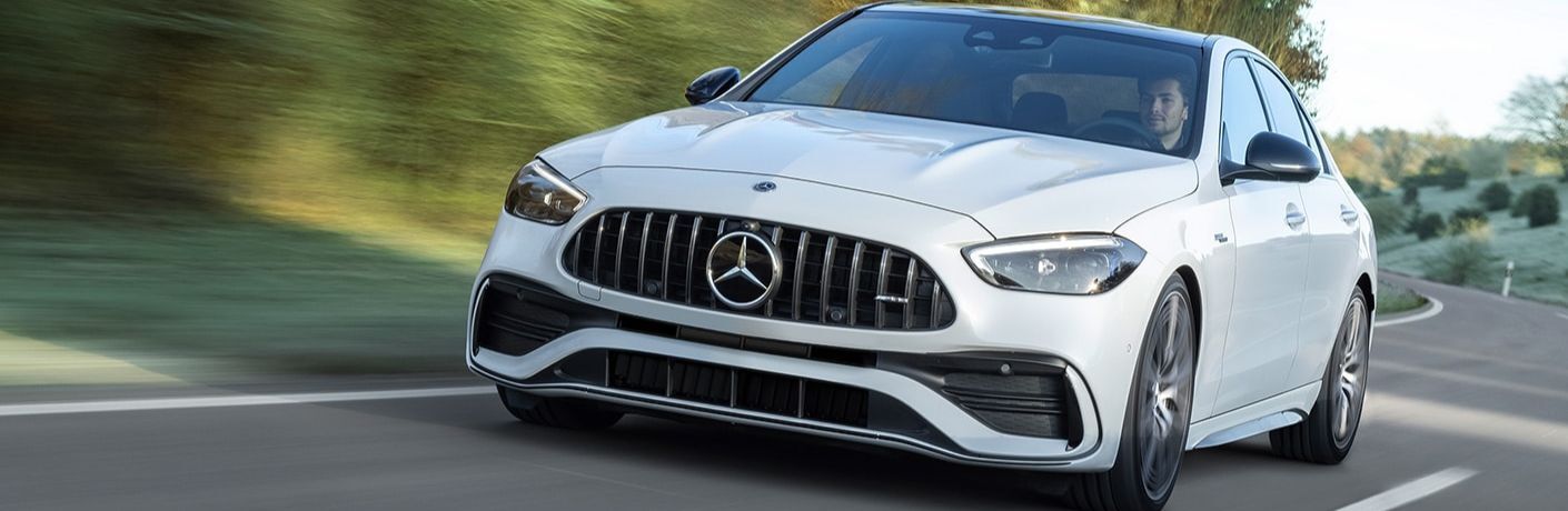 Front view of the 2023 Mercedes-AMG C 43 driving on road