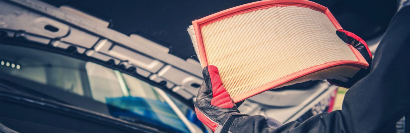 Technician undertaking air filter replacement