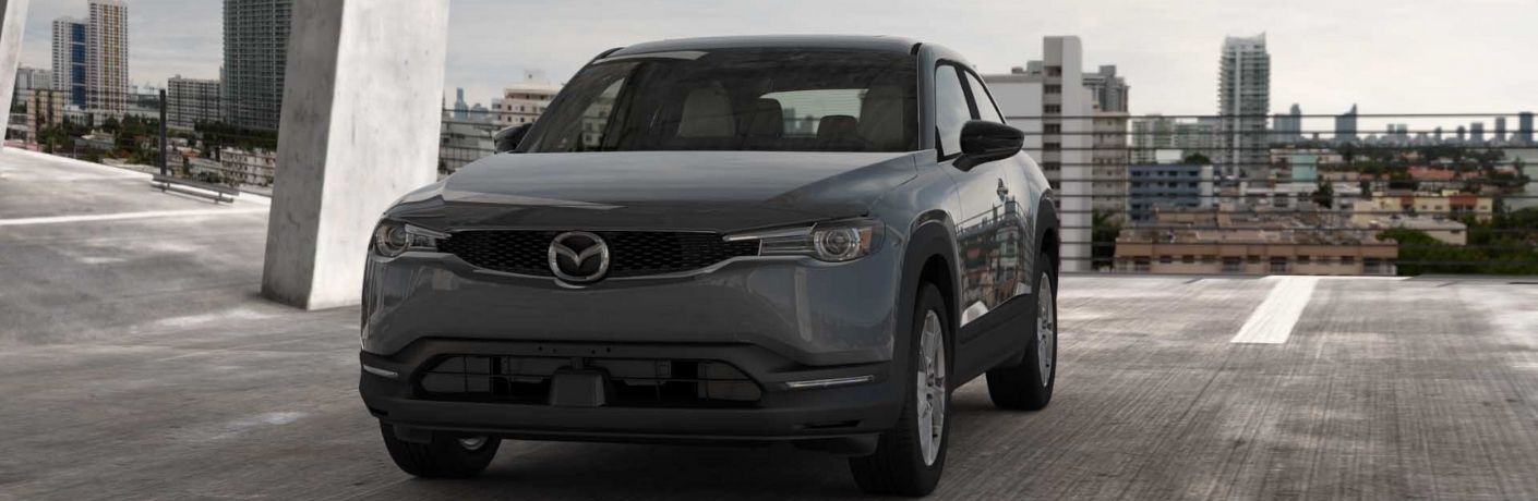 Front view of a metallic 2022 MX-30 EV on a parking lot