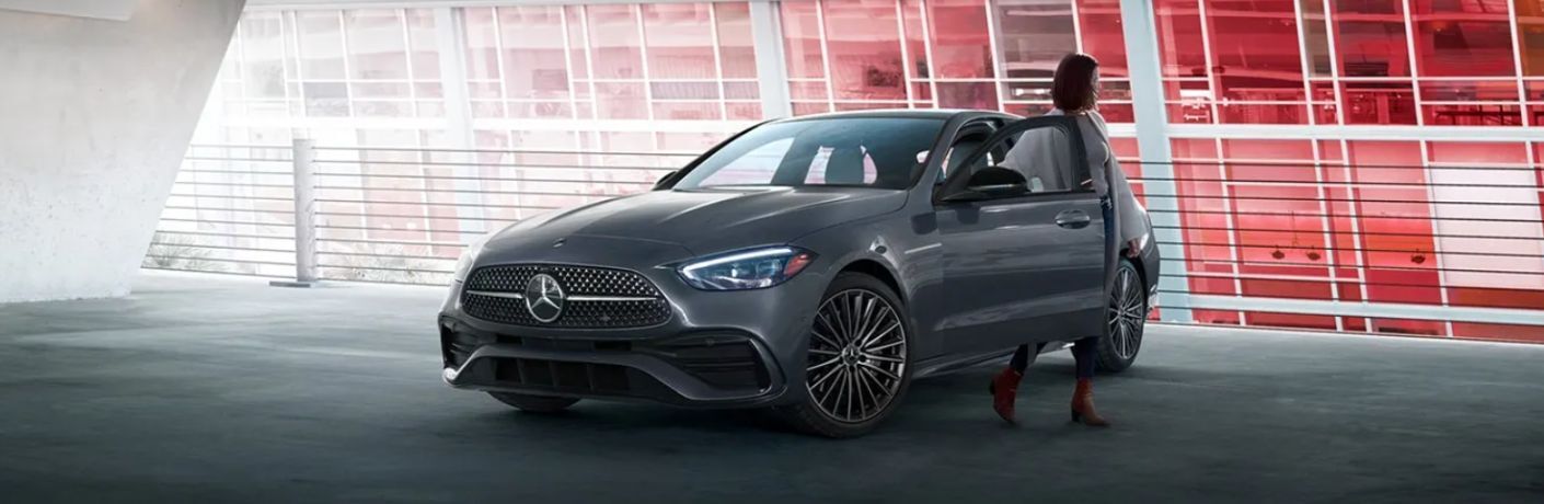 a woman getting out of a 2025 Mercedes-Benz C 300 Sedan