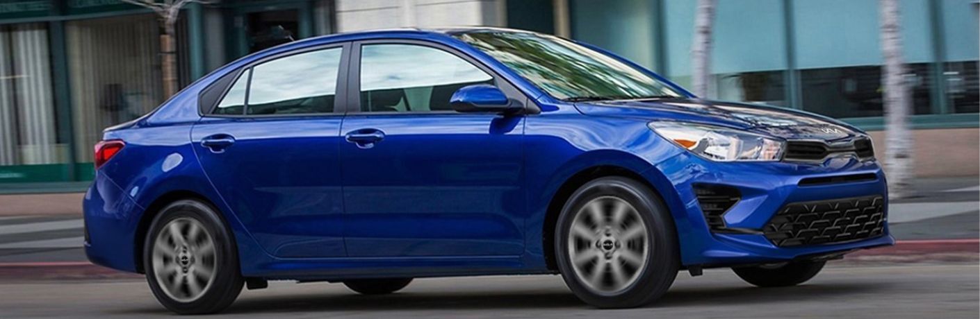 An image of the side view of a blue colored 2023 Kia Rio