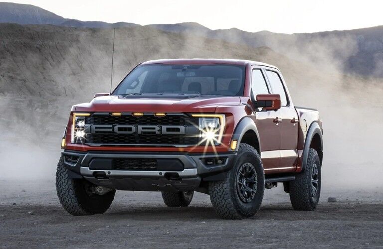 Front driver angle of a red 2021 Ford F-150 Raptor