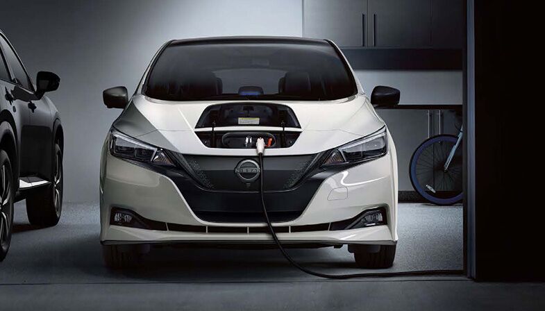 Front view of Nissan EV being charged