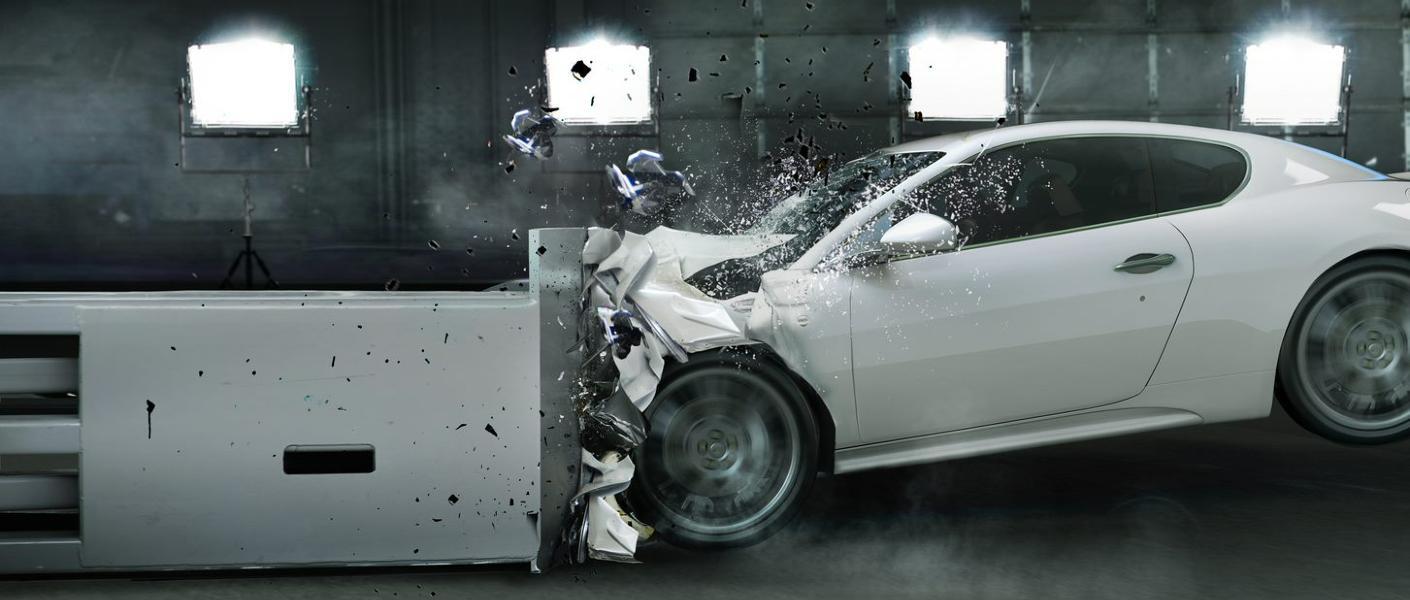 A car undergoing a crash in a crash test facility