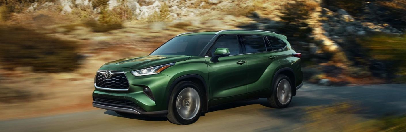 2023 Toyota Highlander Green driving on the road