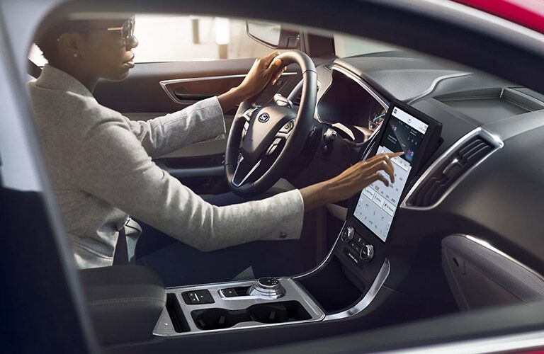 2021 Ford Edge with a woman in the driver's seat