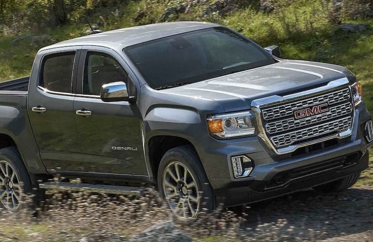 a GMC truck in an off-road path in a hilly area