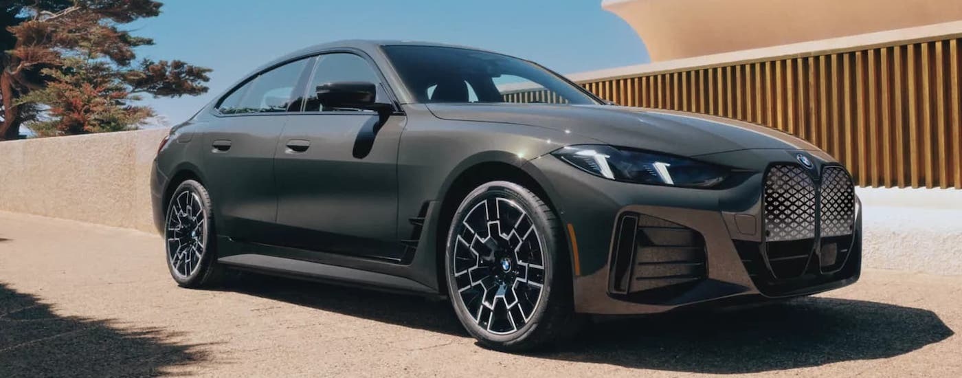 Grey 2023 BMW 4 Series driving down a street.