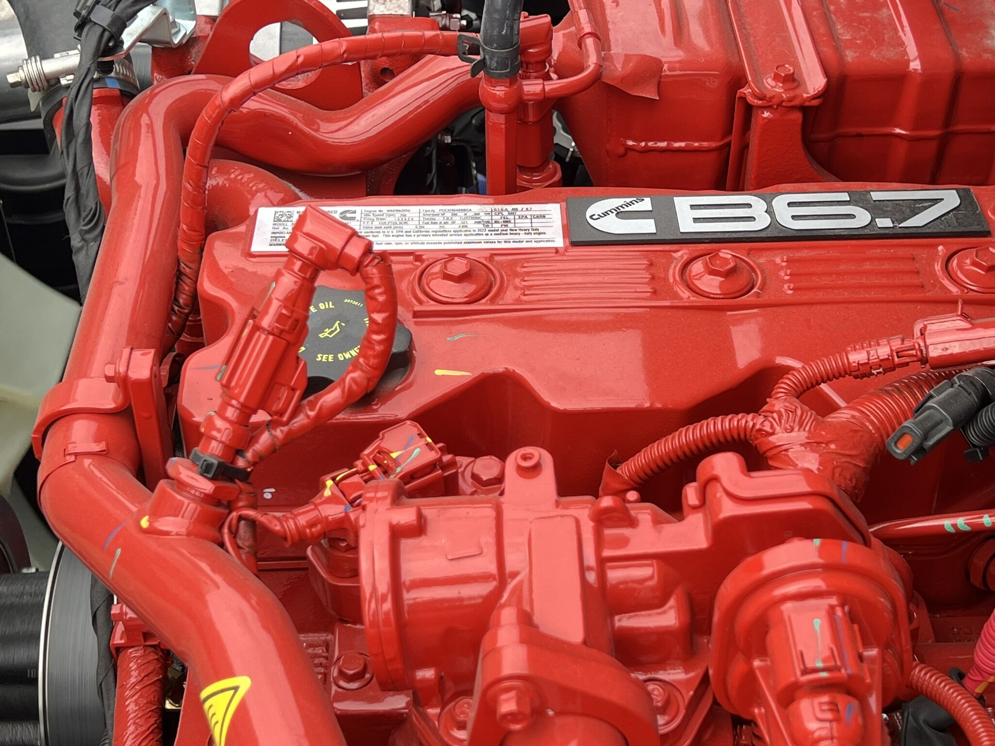 A man performing service on a Cummins commercial truck engine