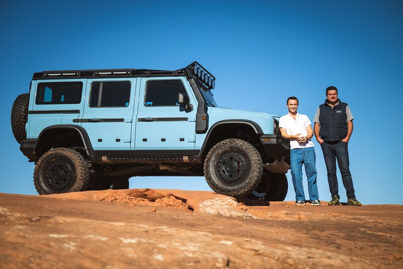 Owners with their Grenadier on slickrock at Oktoberfest 2025 in Moab