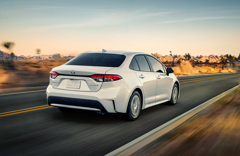 Passenger's side rear angle view of white 2021 Toyota Corolla Hybrid