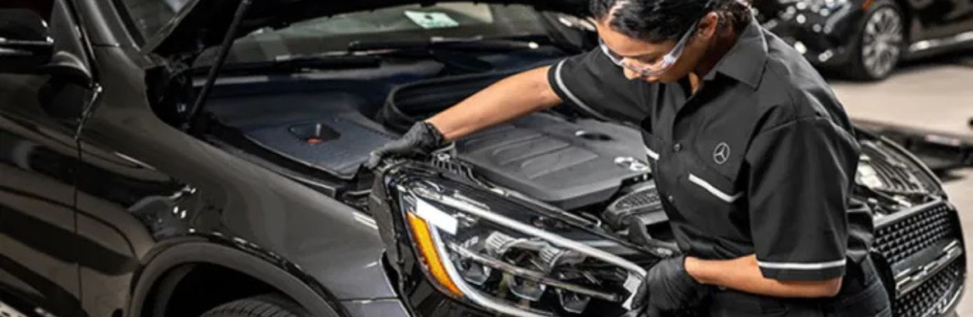 a technician looking at a car