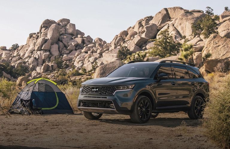 The 2024 Kia Sorento near a camping tent at a desert