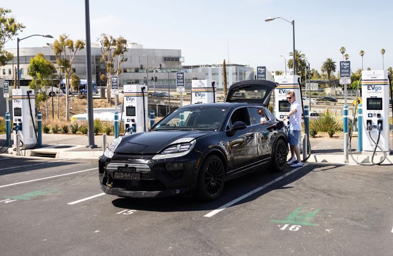 A used 2021 Porsche Macan in black getting charged