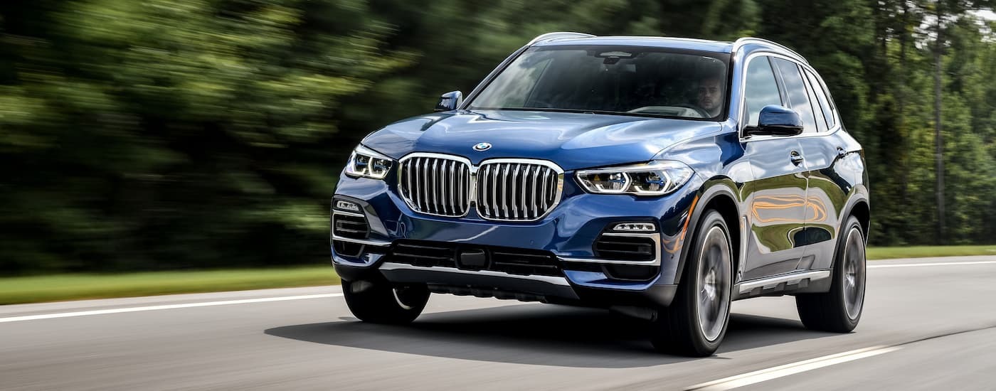 Blue 2018 BMW X5 driving on an open road