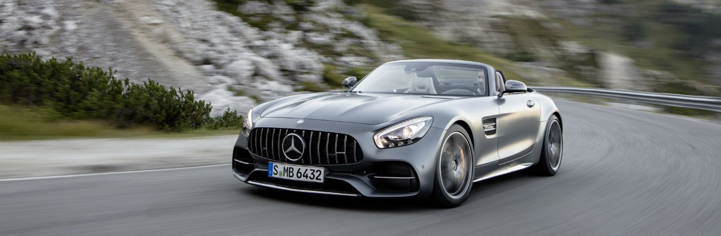 2018 AMG® GT C Roadster driving past mountains