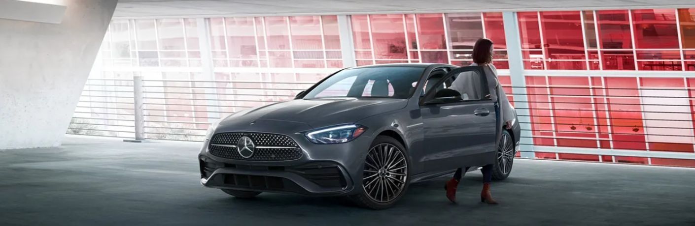 a woman getting out of the 2025 Mercedes-Benz C-Class