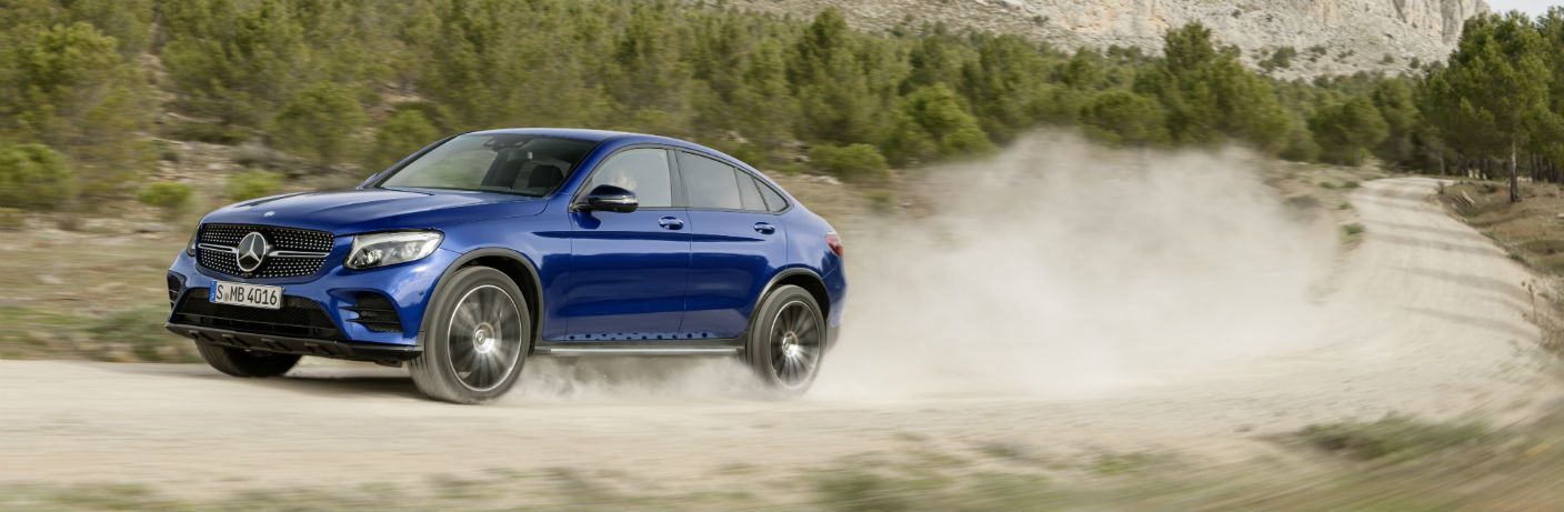 2017 Mercedes-Benz AMG GLC 43 driving on a dusty road
