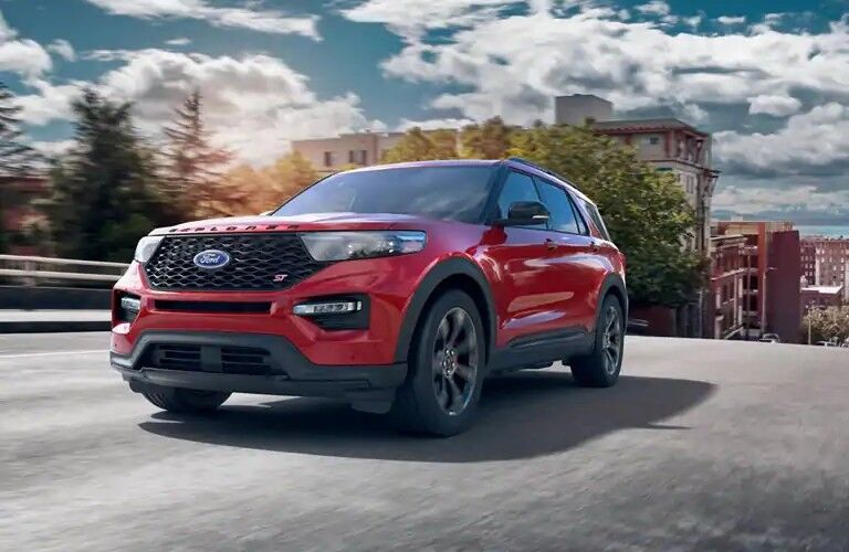 Front view of red 2020 Ford Explorer ST driving on city street