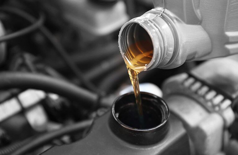 close up of oil being poured into engine