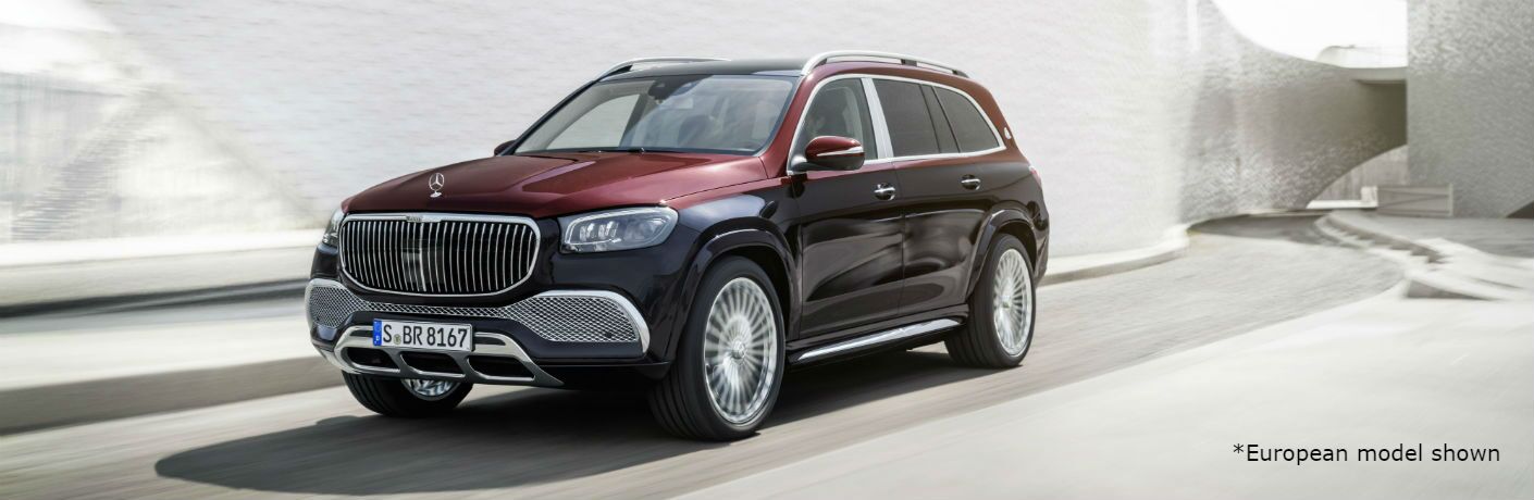 Mercedes-Maybach exterior front fascia driver side going fast on gray road with blurred background