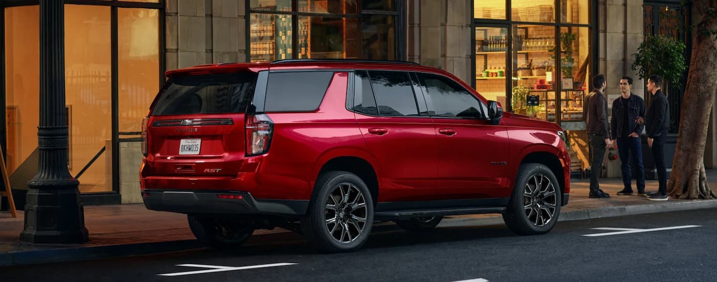Red 2023 Chevy Tahoe RST parked on the side of a city street.