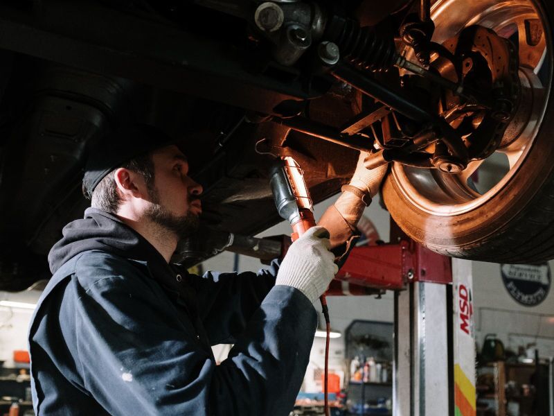 A man checking a wheel before doing the alignment.